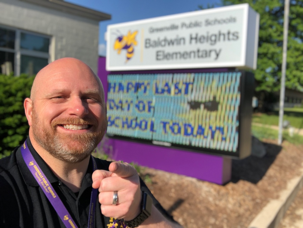 Mr. Walsh in front of electronic sign at baldwin heights